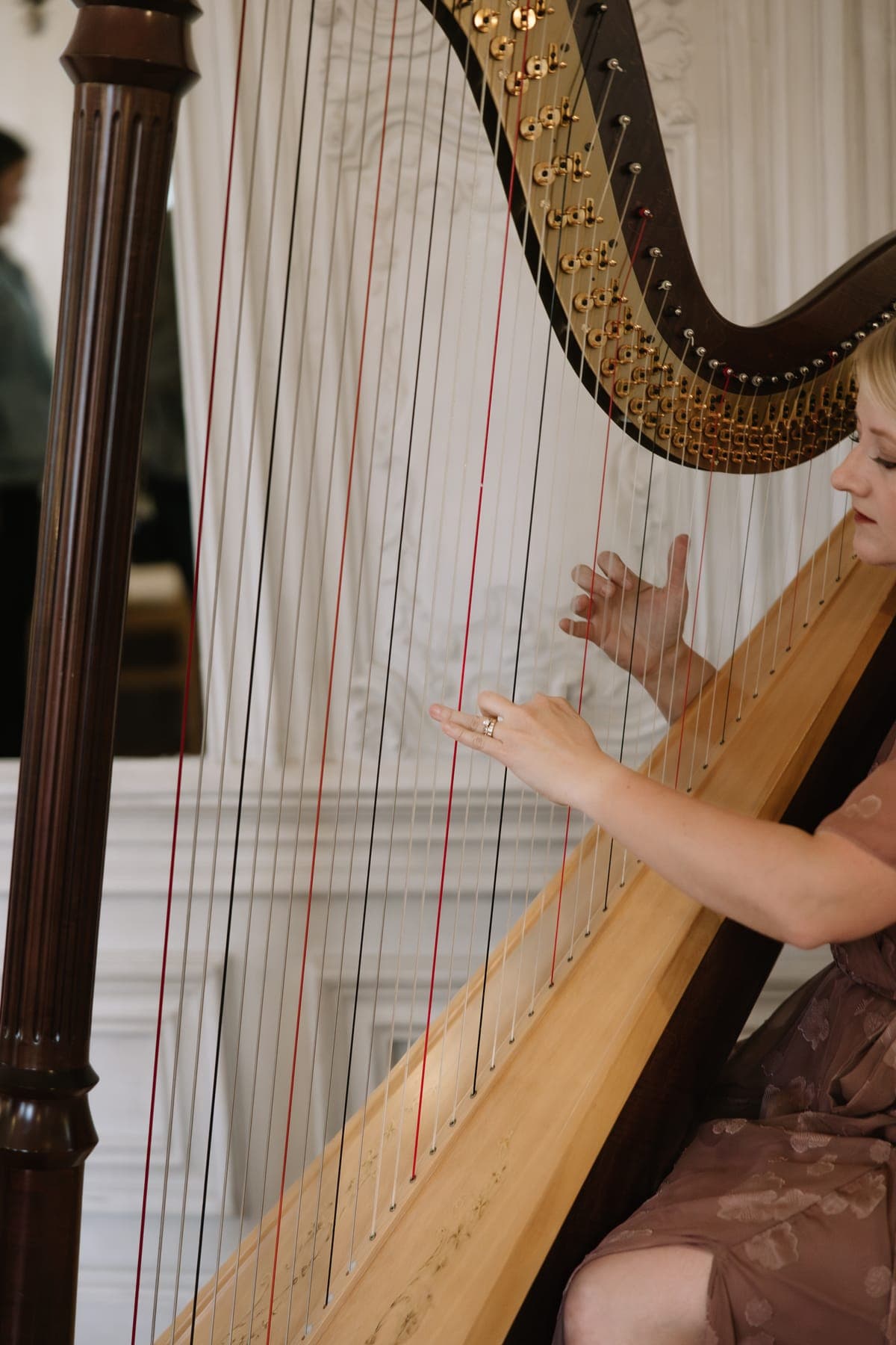 Laura Neil performing harp music at a styled Utah wedding